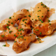sauced buffalo wings on plate